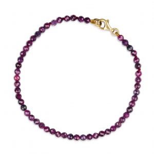 “Ruby Gemstone Bracelet with faceted pinky-red rubies and precious metal clasp.”