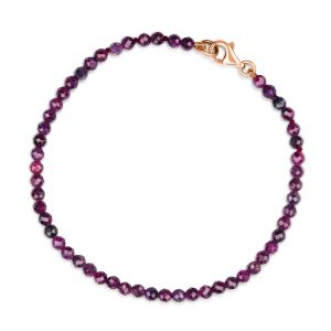 “Ruby Gemstone Bracelet with faceted pinky-red rubies and precious metal clasp.”