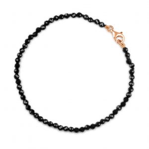 “Onyx Gemstone Bracelet with faceted black onyx beads and precious metal clasp.”