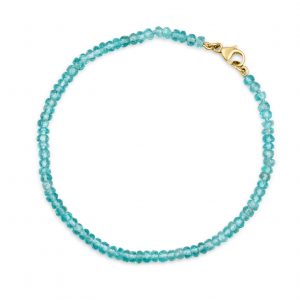 “Blue Apatite Gemstone Bracelet with faceted blue apatite beads and precious metal clasp.”
