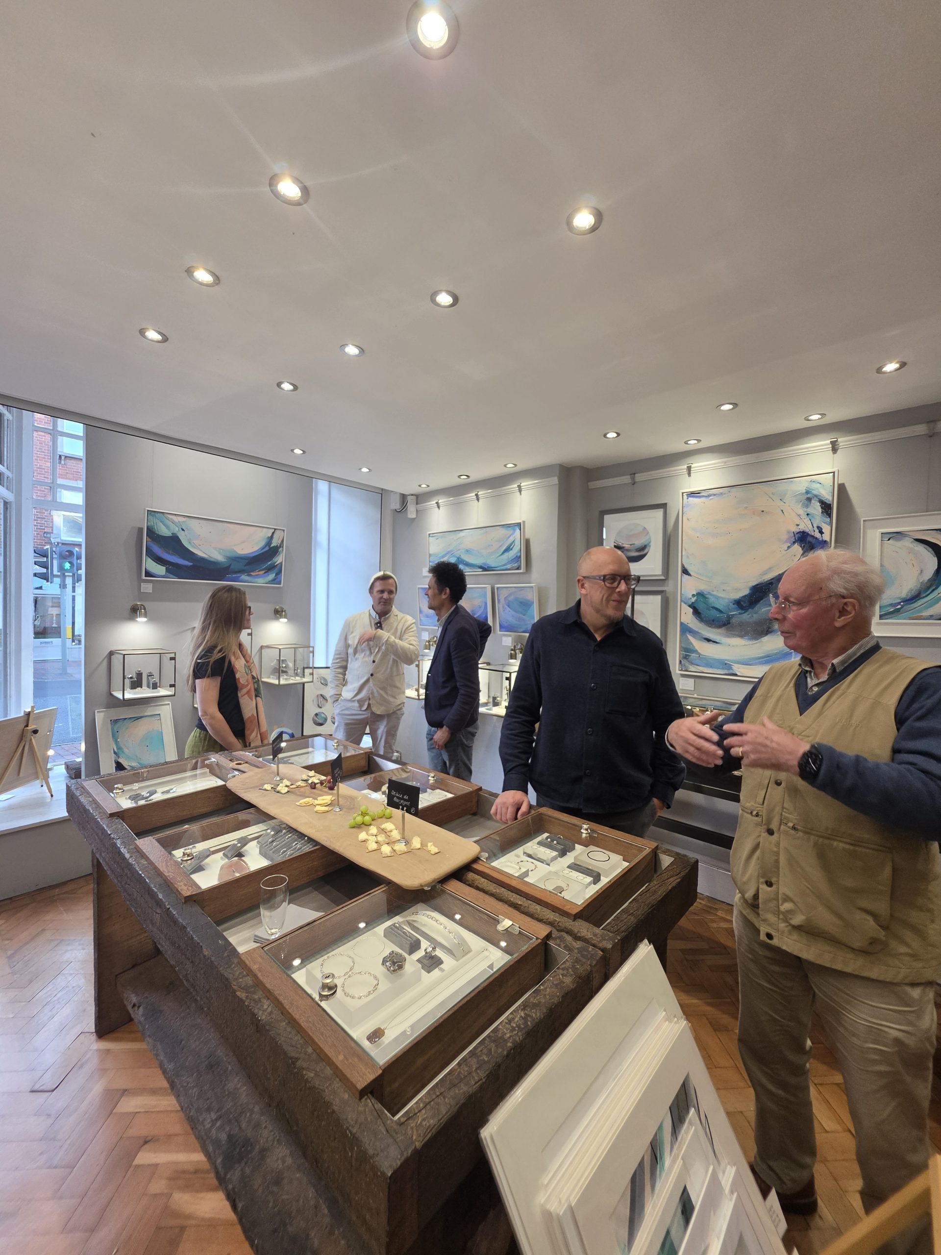 Guests gathered around KATA's jewellery displays during an afternoon of art and conversation at the gallery.